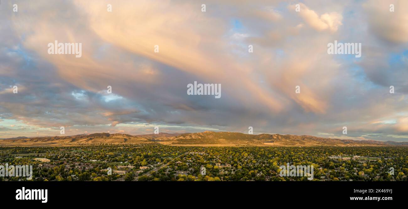 early morning over Fort Collins and foothills of Rocky Mountains in northern Colorado, aerial panorama with dramatic clouds Stock Photo