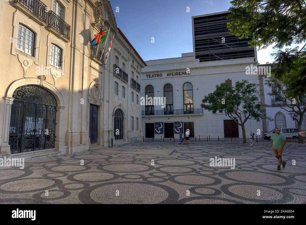 Aveiro, Portugal - August 14, 2022: Theater (Teatro) Aveirense located next to district council building with motion blurred pedestrians in foreground Stock Photo