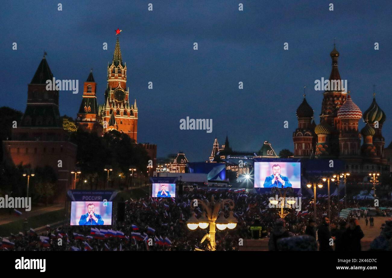 Denis Pushilin, the Russian-installed leader in Ukraine's Donetsk region, is seen on screens during a concert marking the declared annexation of the Russian-controlled territories of four Ukraine's Donetsk, Luhansk, Kherson and Zaporizhzhia regions, after holding what Russian authorities called referendums in the occupied areas of Ukraine that were condemned by Kyiv and governments worldwide, near the Kremlin and Red Square in central Moscow, Russia, September 30, 2022. REUTERS/REUTERS PHOTOGRAPHER Stock Photo