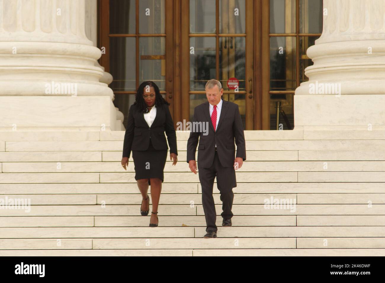 Washington DC, USA. 30 Sep 2022. Ketanji Brown Jackson, the first African-American woman to serve on the U.S. Supreme Court, walks down the courthouse steps with Chief Justice John Roberts following her ceremonial swearing-in. Credit: Philip Yabut/Alamy Live News Stock Photo