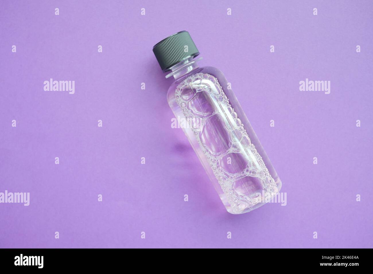 mouthwash liquid in a container on purple background Stock Photo Alamy