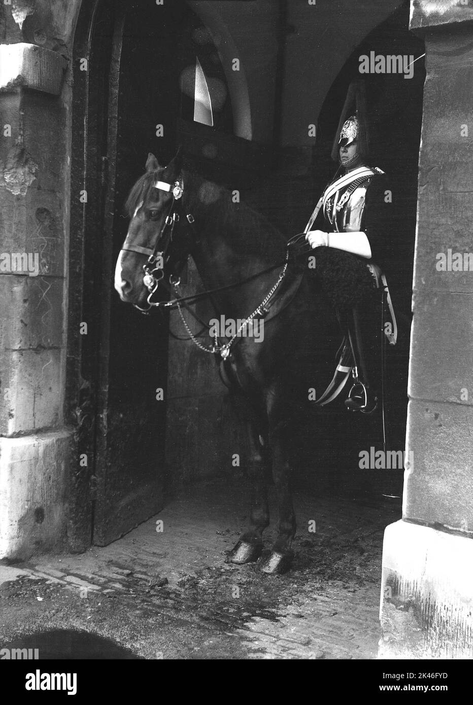 1958, historical, a King's Life Guard on horseback, on sentry duty to Horse Guards, the official entrance to the Palace of Whitehall, Westminster, London, England, UK. The mounted guardsman is wearing full uniform, tunic and ceremonial headgear known as an Albert helmet. Stock Photo