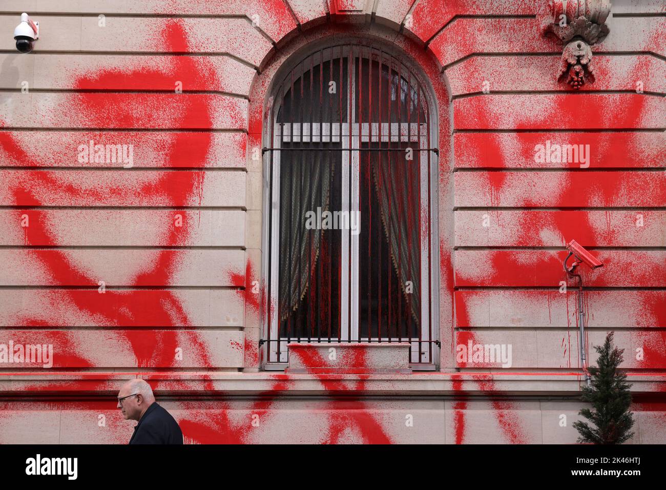 A person walks by as red paint is seen on the building of the Consulate General of the Russian Federation after it was vandalized in Manhattan, New York City, U.S., September 30, 2022.  REUTERS/Andrew Kelly Stock Photo