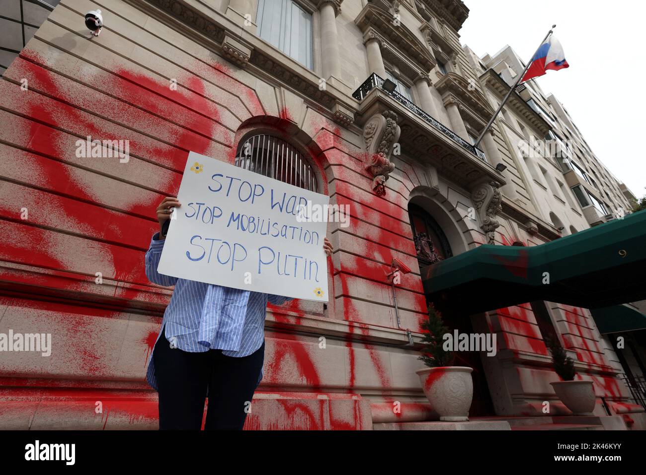 A protestor stands outside of the building of the Consulate General of the Russian Federation after it was vandalized with red paint in Manhattan, New York City, U.S., September 30, 2022.  REUTERS/Andrew Kelly Stock Photo