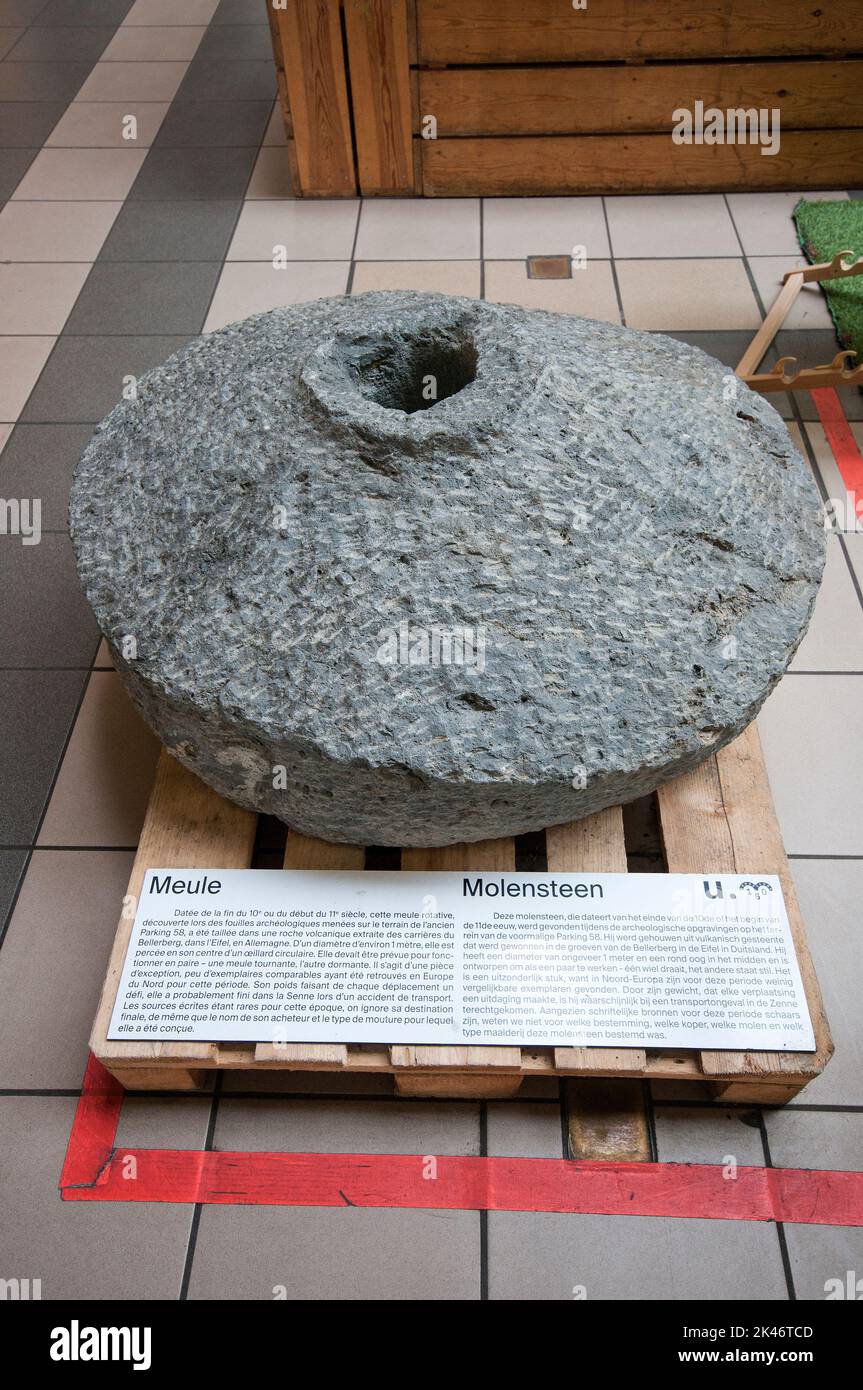 Ancient grinding wheel (X-XI century) on display at Halle Saint-Gery cultural center, Brussels, Belgium Stock Photo