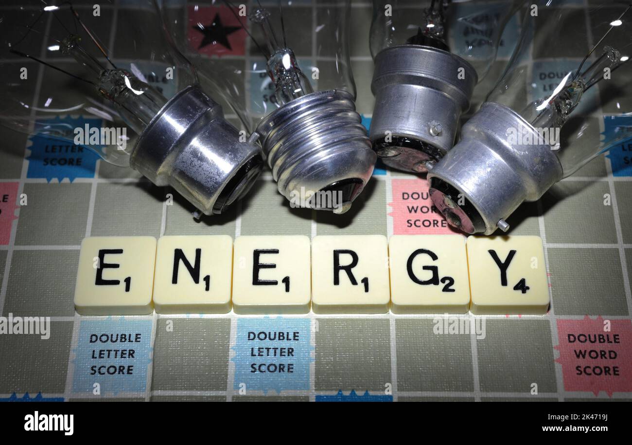 WORD GAME TILES SPELLING 'ENERGY' WITH ELECTRIC LIGHT BULBS RE COST OF LIVING CRISIS RISING COSTS BILLS GAS ELECTRICITY ETC UK Stock Photo