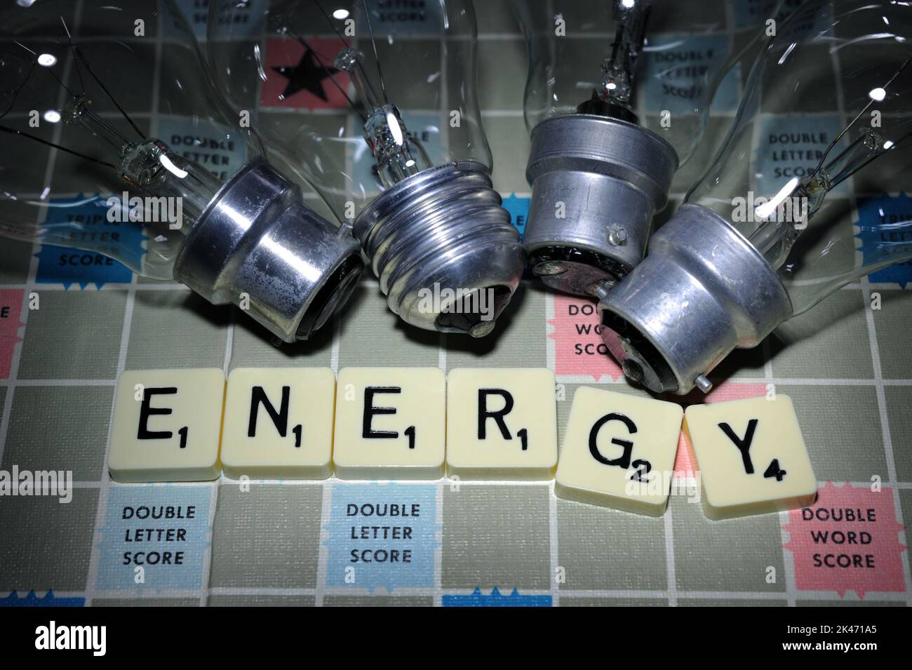 WORD GAME TILES SPELLING 'ENERGY' WITH ELECTRIC LIGHT BULBS RE COST OF LIVING CRISIS RISING COSTS BILLS GAS ELECTRICITY ETC UK Stock Photo