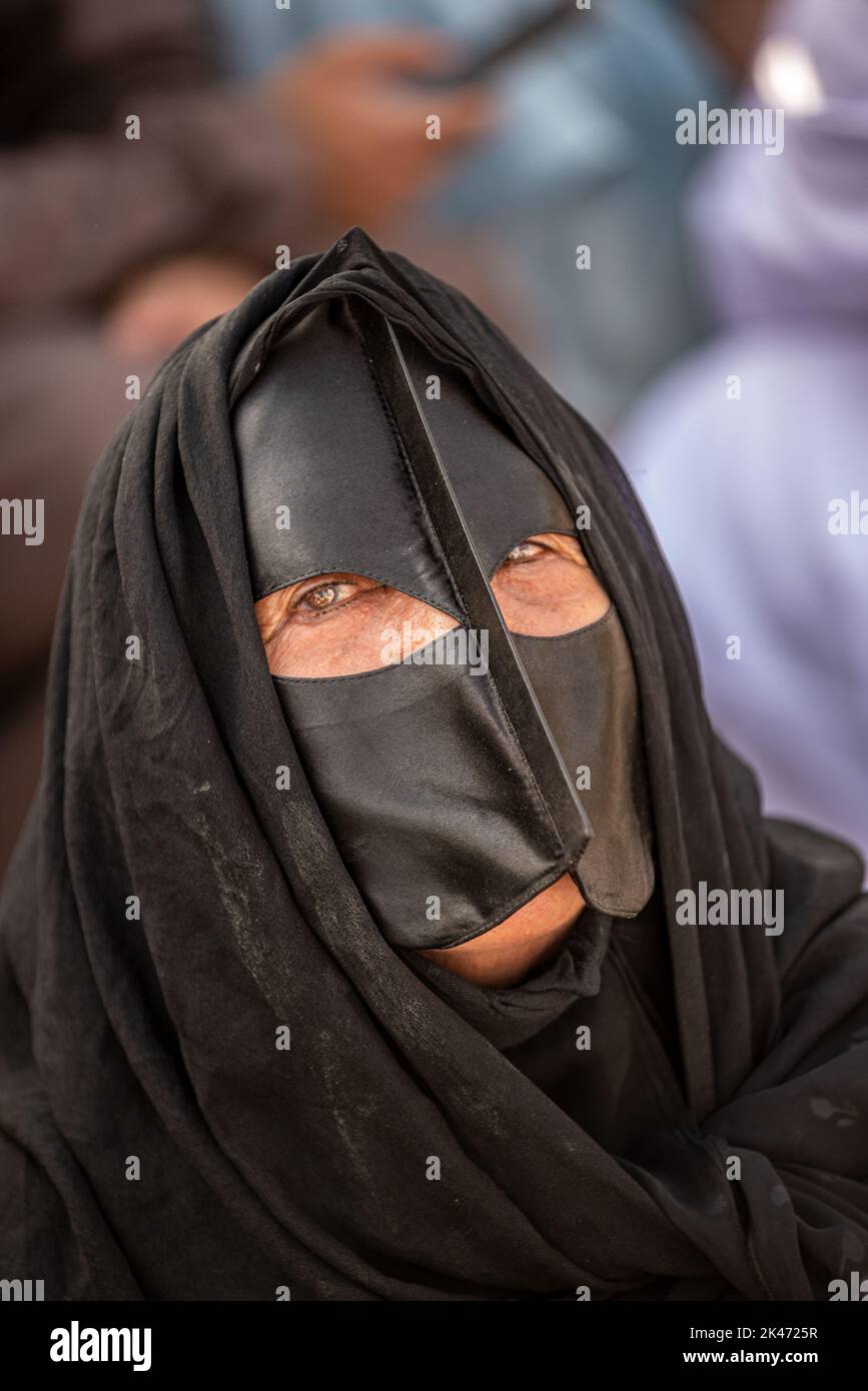 Woman with black "battoulah" (face mask) at friday morning cattle