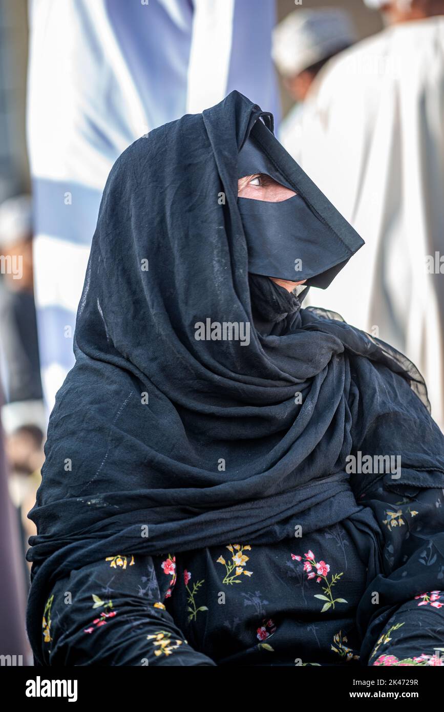 Woman with black 'battoulah' (face mask) at friday morning cattle market, Nizwa, Oman Stock Photo