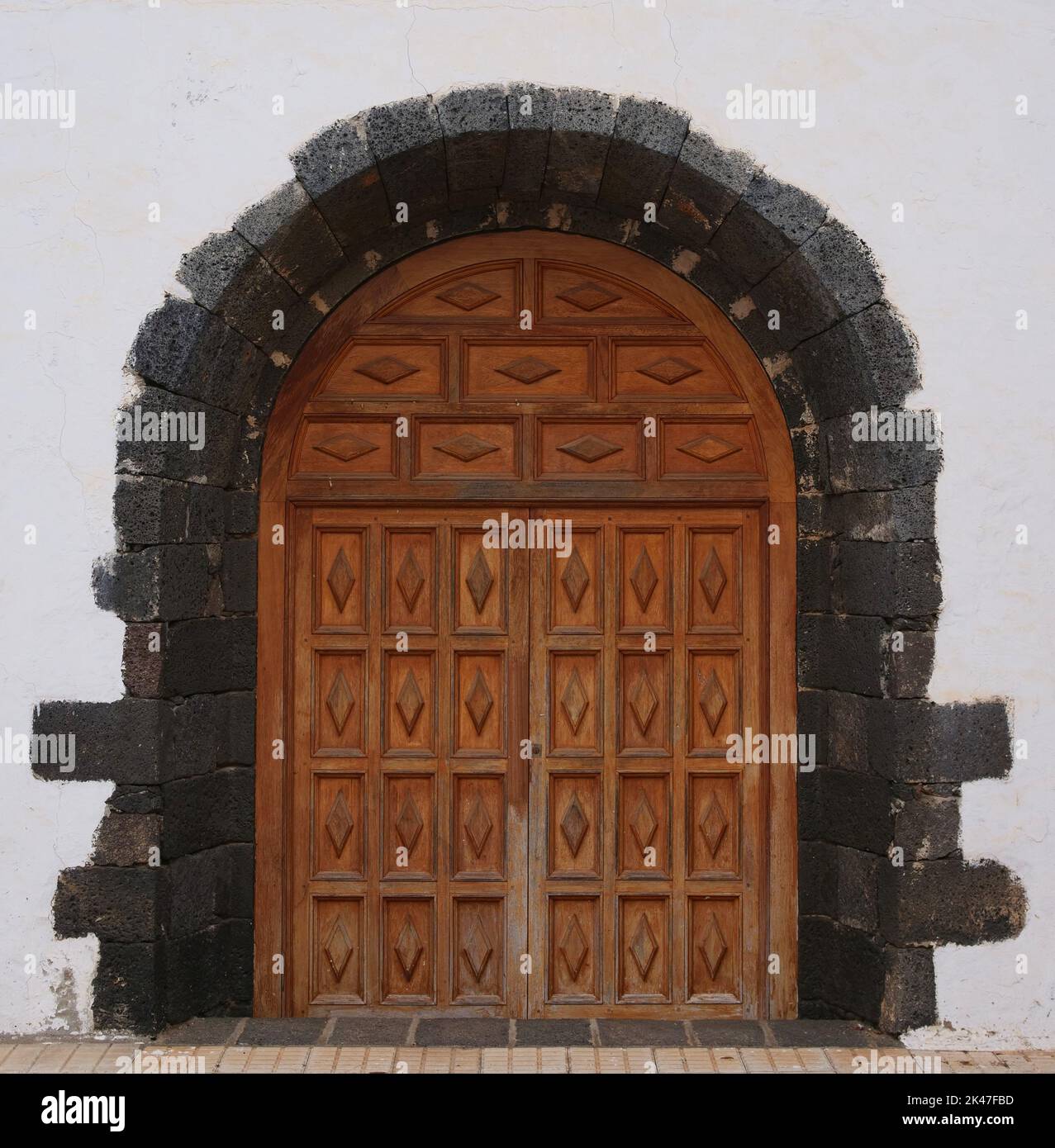 Old wooden door from a church with stone round arch Stock Photo
