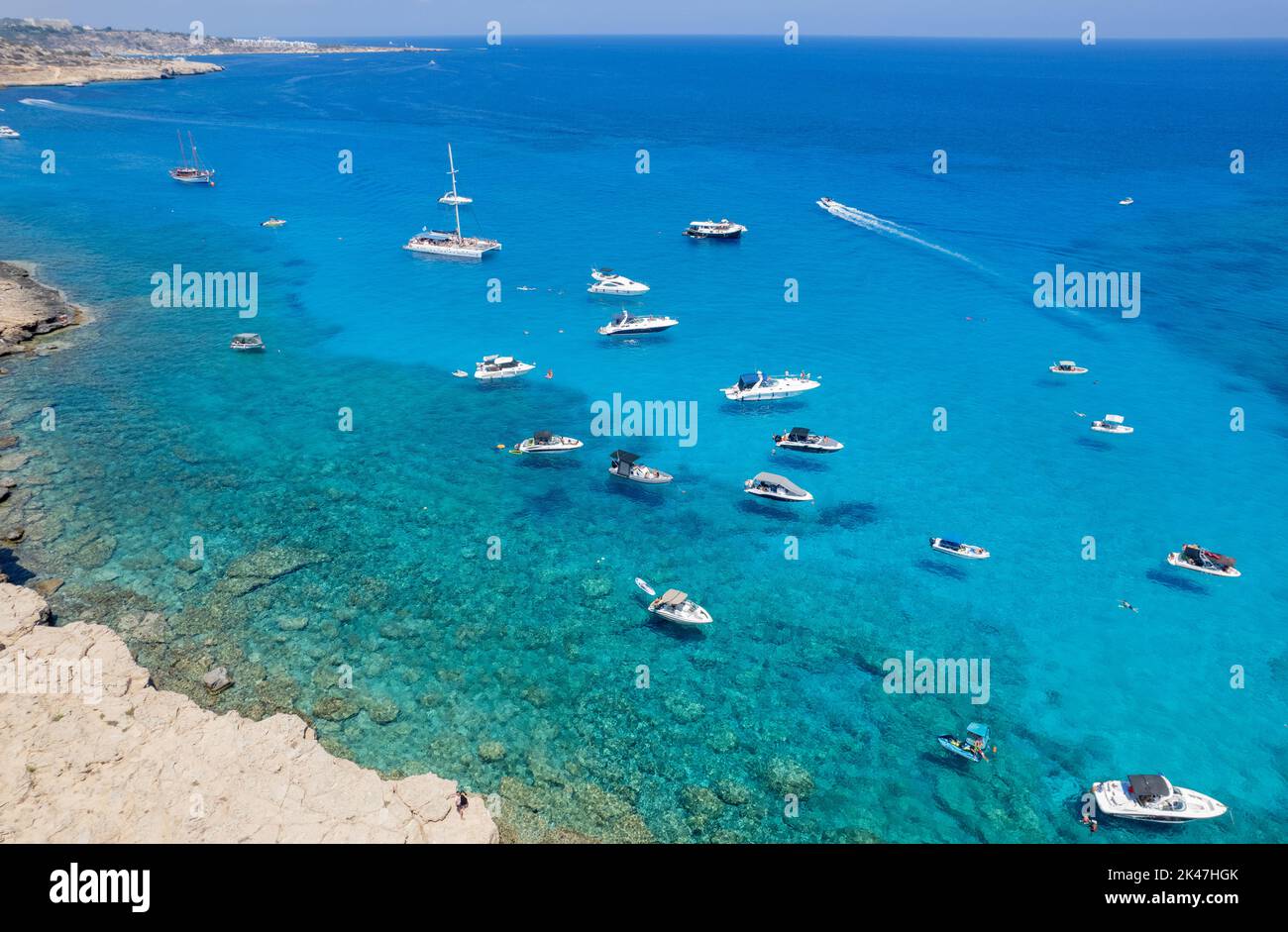 Drone aerial seascape luxury yachts moored and unrecognised people swimming and relaxing. Summer vacations in the sea. Ayia Napa Cyprus Stock Photo