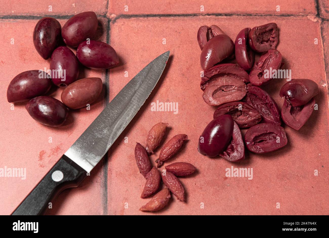 Kalamata olives with knife Stock Photo