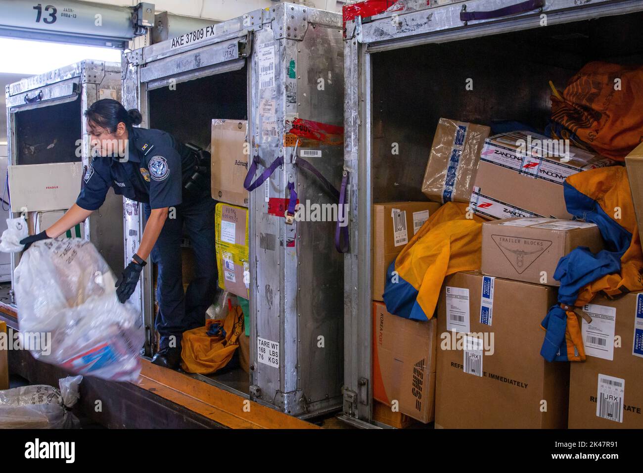 Customs and Border Protection officers assigned to the Area Port of Jacksonville, Florida perform consignment inspections of foreign packages arriving to the United States on Feb. 20. Photo by Ozzy Trevino, U.S. Customs and Border Protection Stock Photo