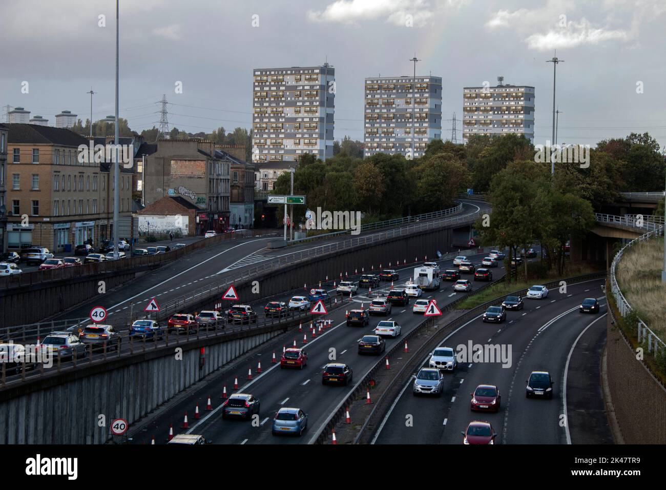 View of the A804 from the pedestrian bridge with the sixties tower blocks of the Woodside area of Glasgow in the background, Scotland, UK Stock Photo