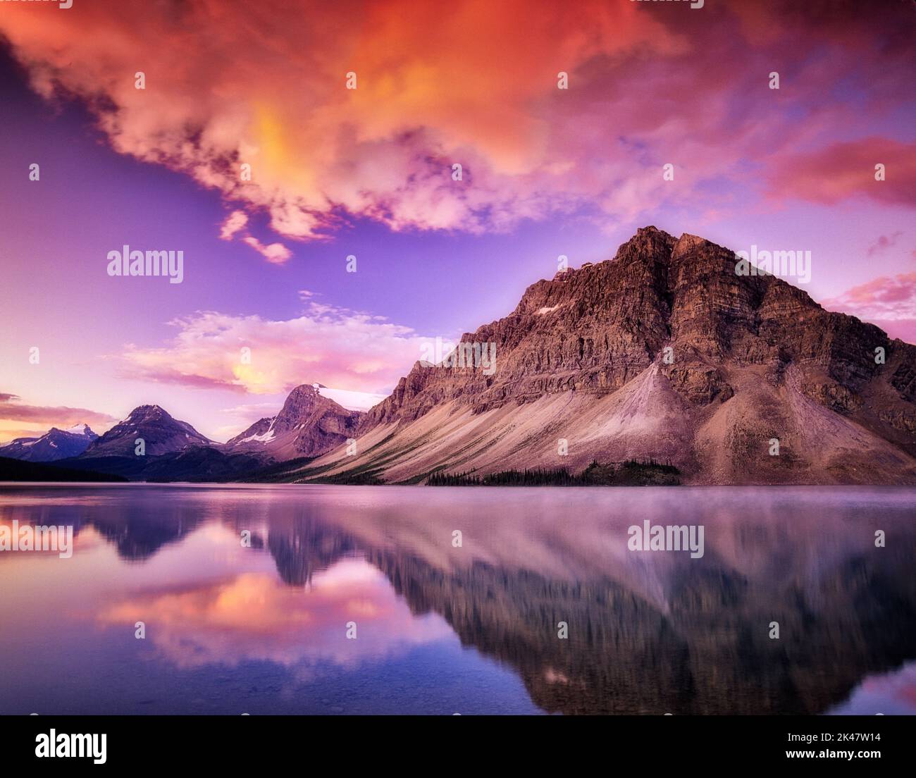 Bow Lake reflection with clouds and sunrise. Banff National Park, Canada Stock Photo