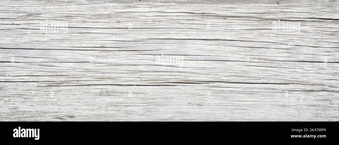 Wood plank texture background, old white wooden board from barn close-up. Weathered light rough timber with cracks and grain, vintage rustic dry wood. Stock Photo