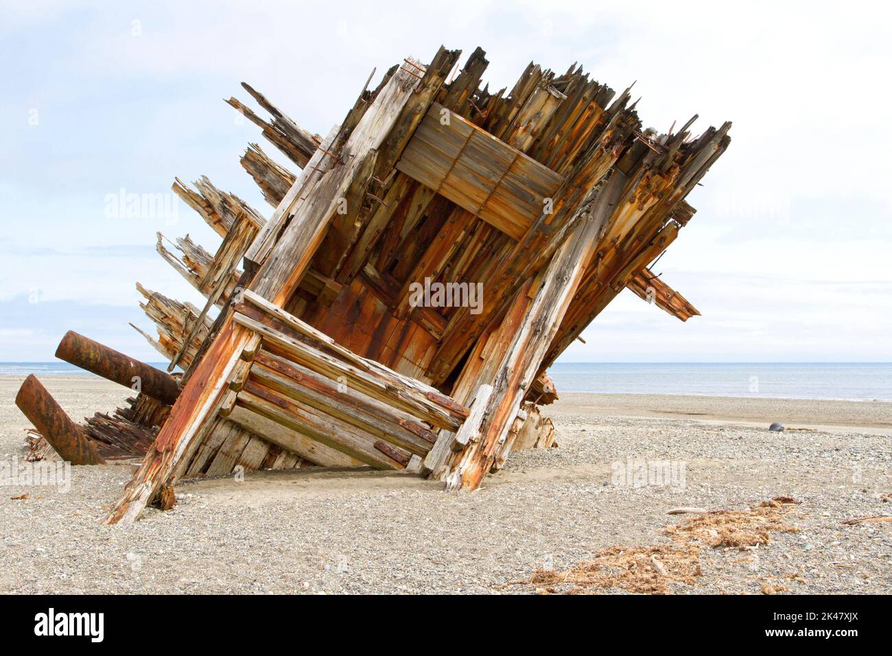 The remaining hull of the Pesuta shipwreck lying in sand north of Tlell River on East Beach in the Naikoon Provincial Park, Haida Gwaii, BC, Canada Stock Photo