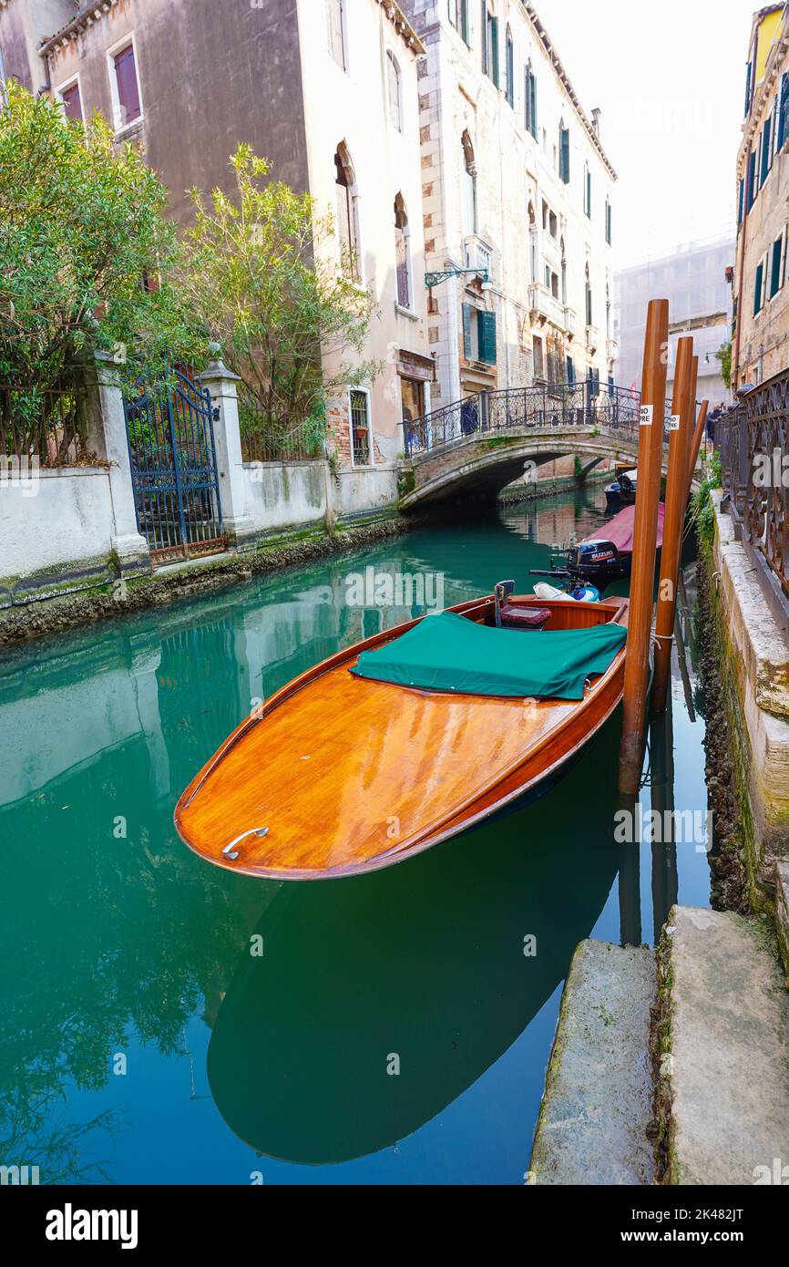 A traditional Venician gondola moored in one of the city's famous canals Stock Photo