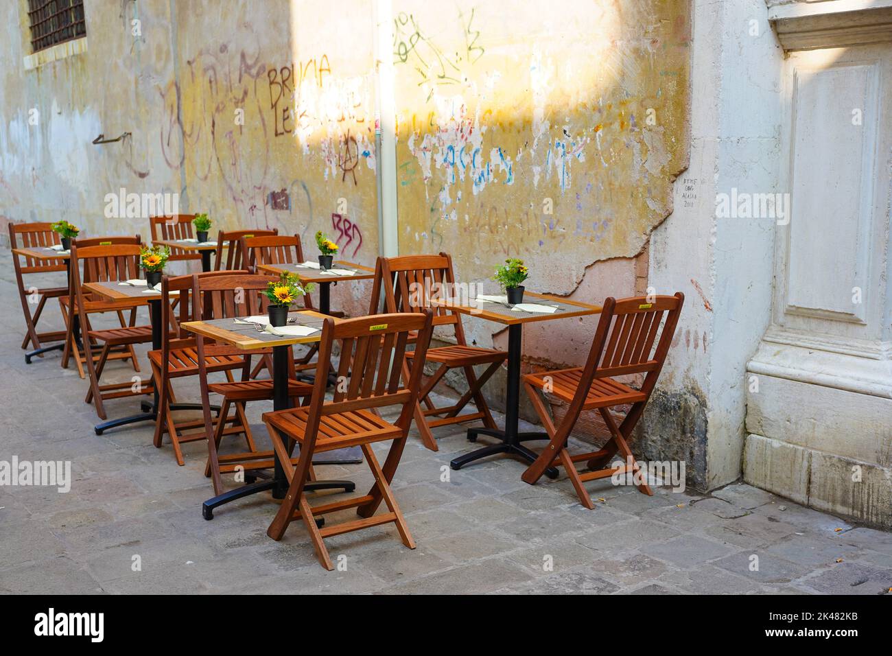 Wooden cafe seating in the Italian city of Venice Stock Photo