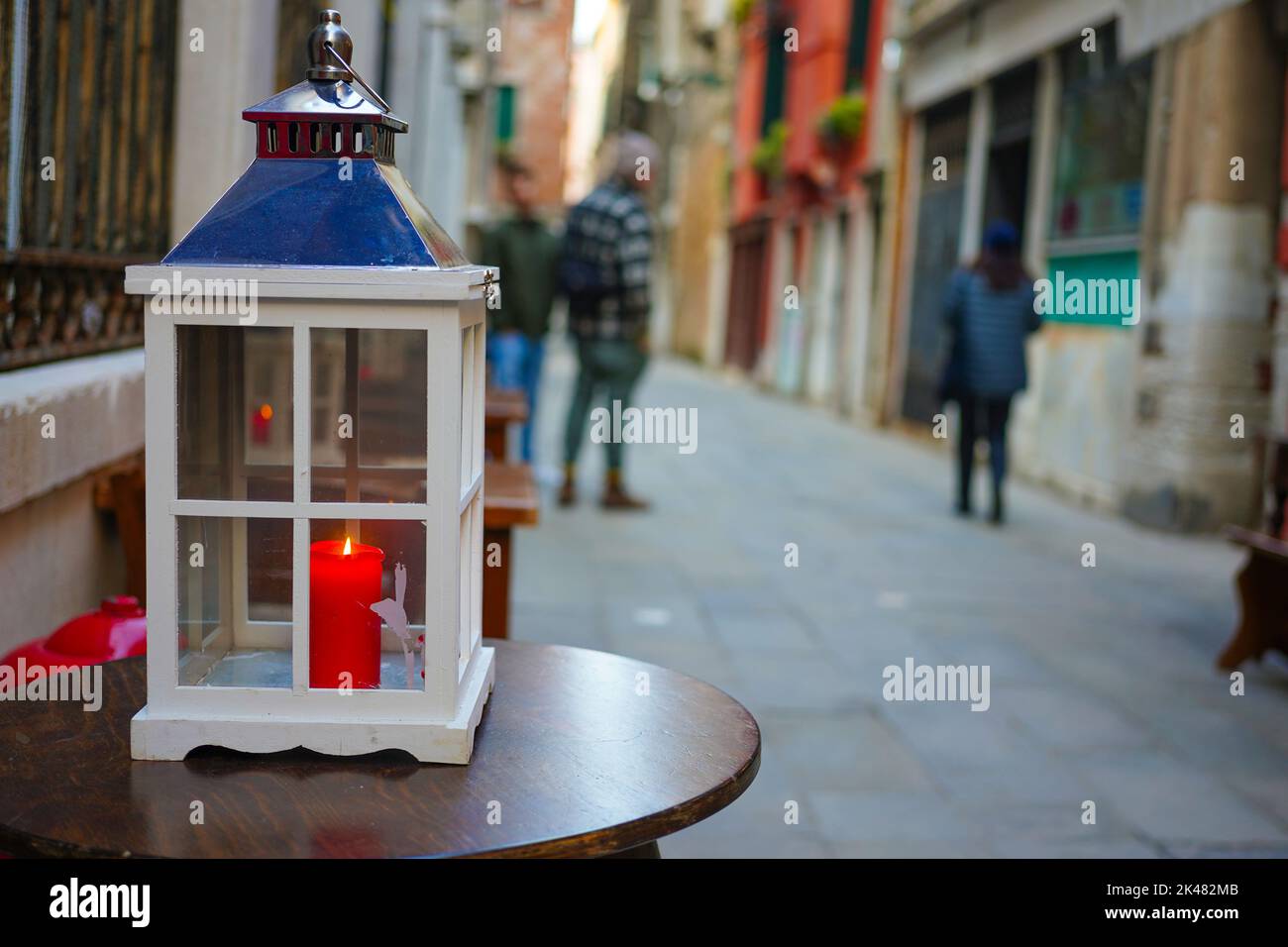 A candle on a cafe table in an alleyway of Venice, Italy Stock Photo