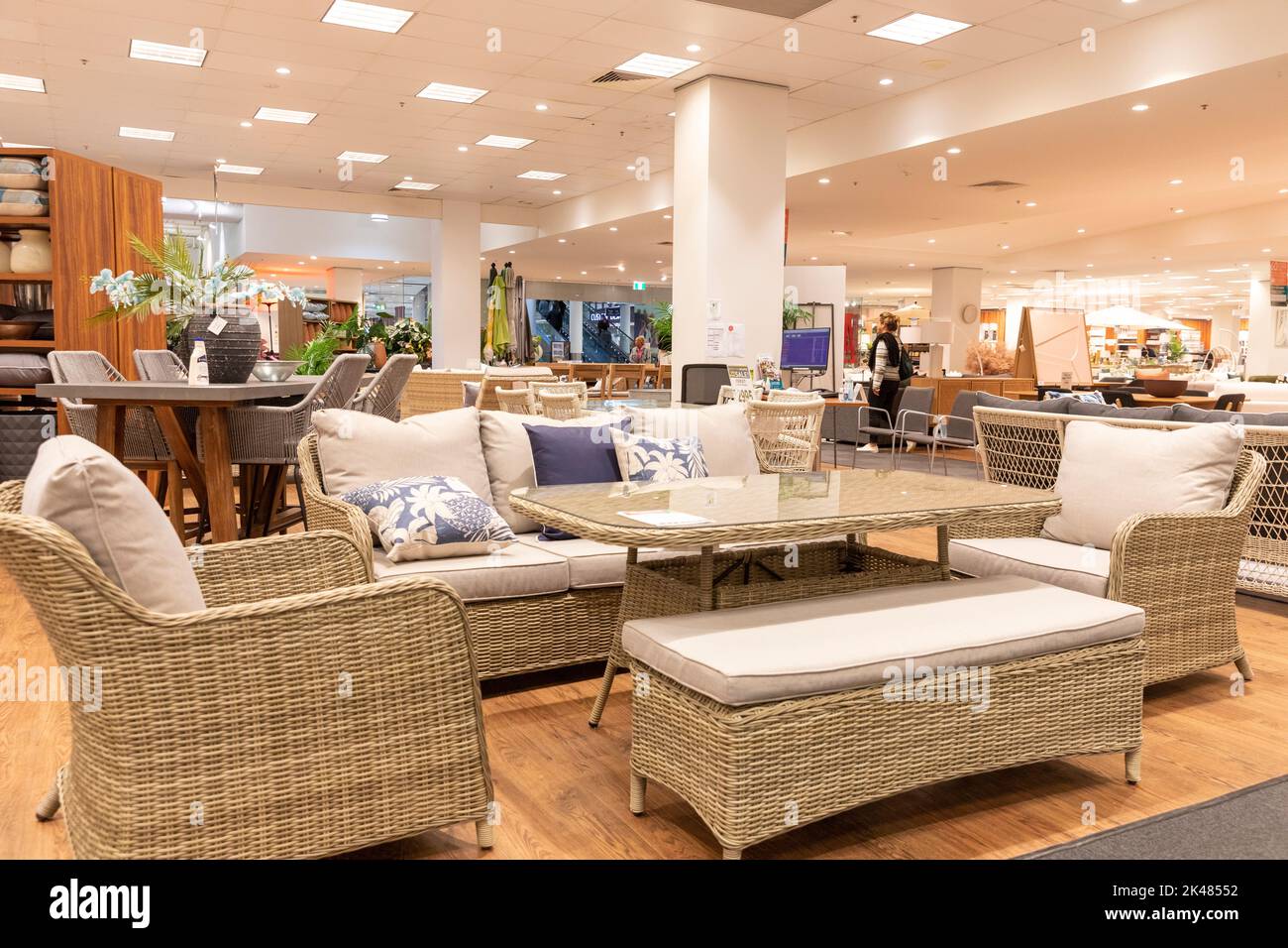 Wicker style outdoor furniture set, table and sofa and chairs with bench,Harvey Norman store in Belrose Sydney,Australia Stock Photo