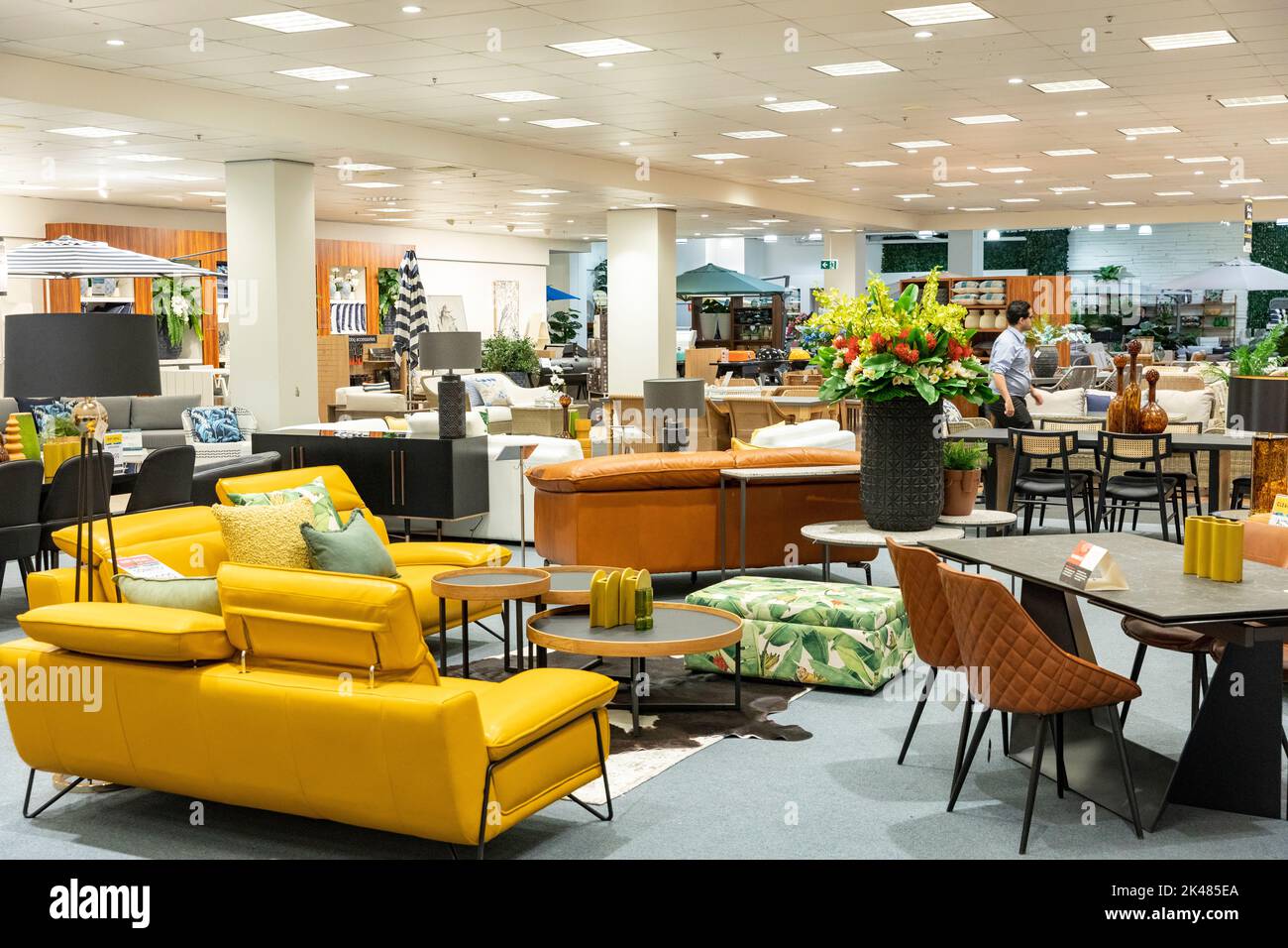 Domayne Harvey Norman furniture store interior, leather yellow sofa on display, furniture and homewares, Sydney,Australia,2022 Stock Photo