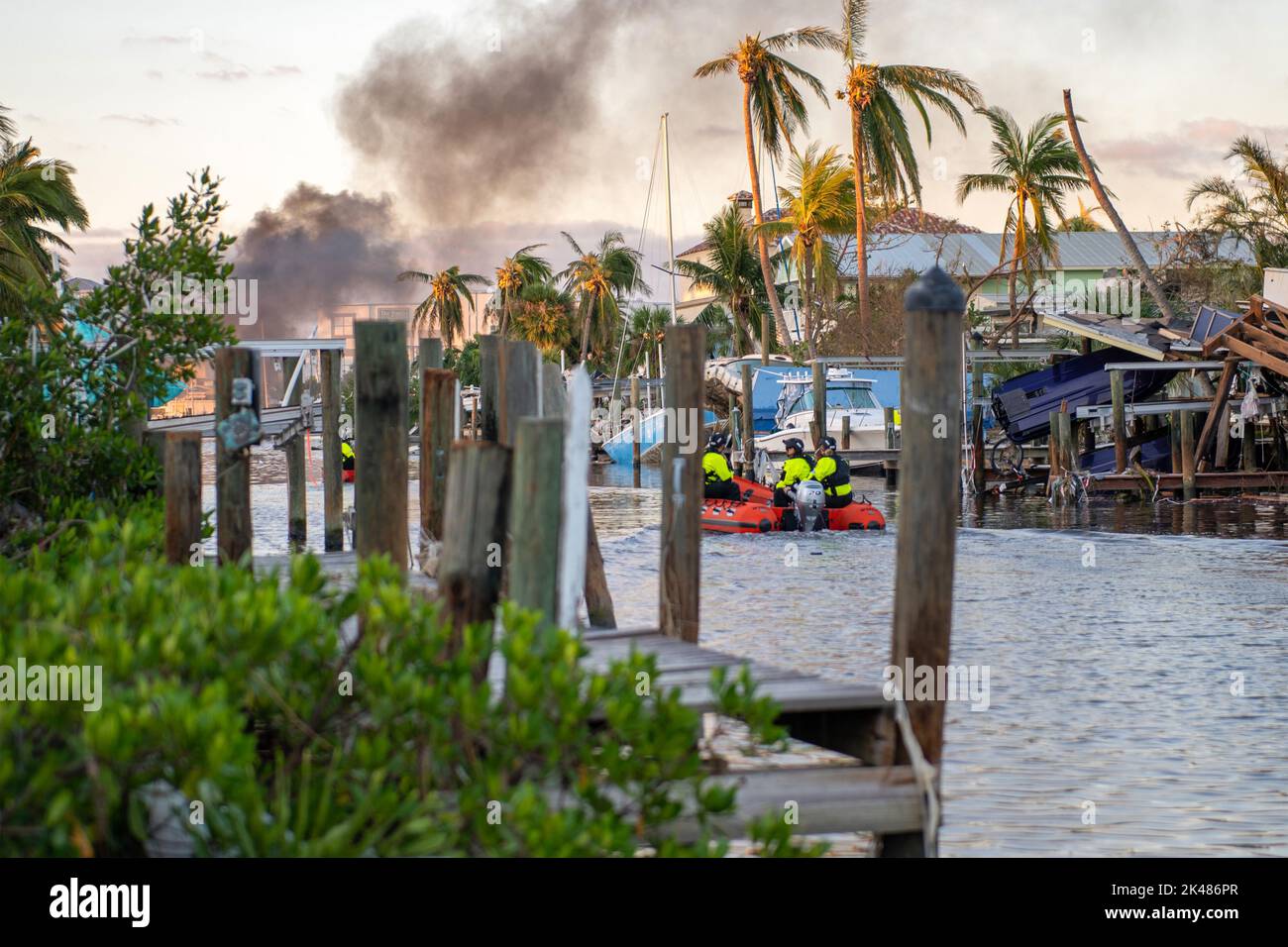 In the aftermath of catastrophic Hurricane Ian, Coast Guard personnel navigate canals in Fort Myers Beach, Florida, during search and rescue operations on September 29, 2022. (USA) Stock Photo