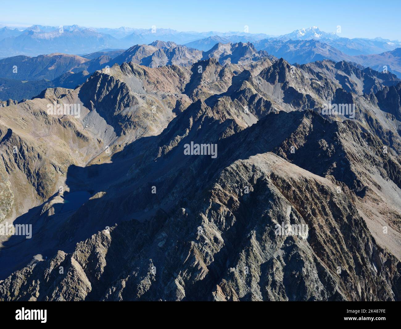 AERIAL VIEW. Large panorama of the Belledonne Massif with the Mont Blanc summit in the distance. Isère and Savoie, Auvergne-Rhône-Alpes, France. Stock Photo