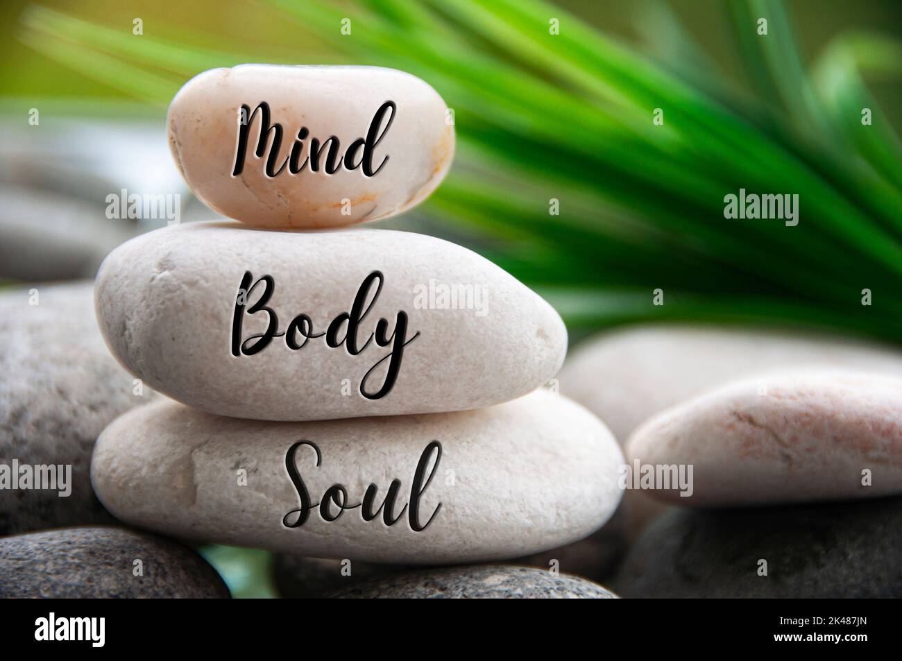 Mind, Body and Soul words engraved on zen stones with space for text. Copy space and zen concept. Stock Photo