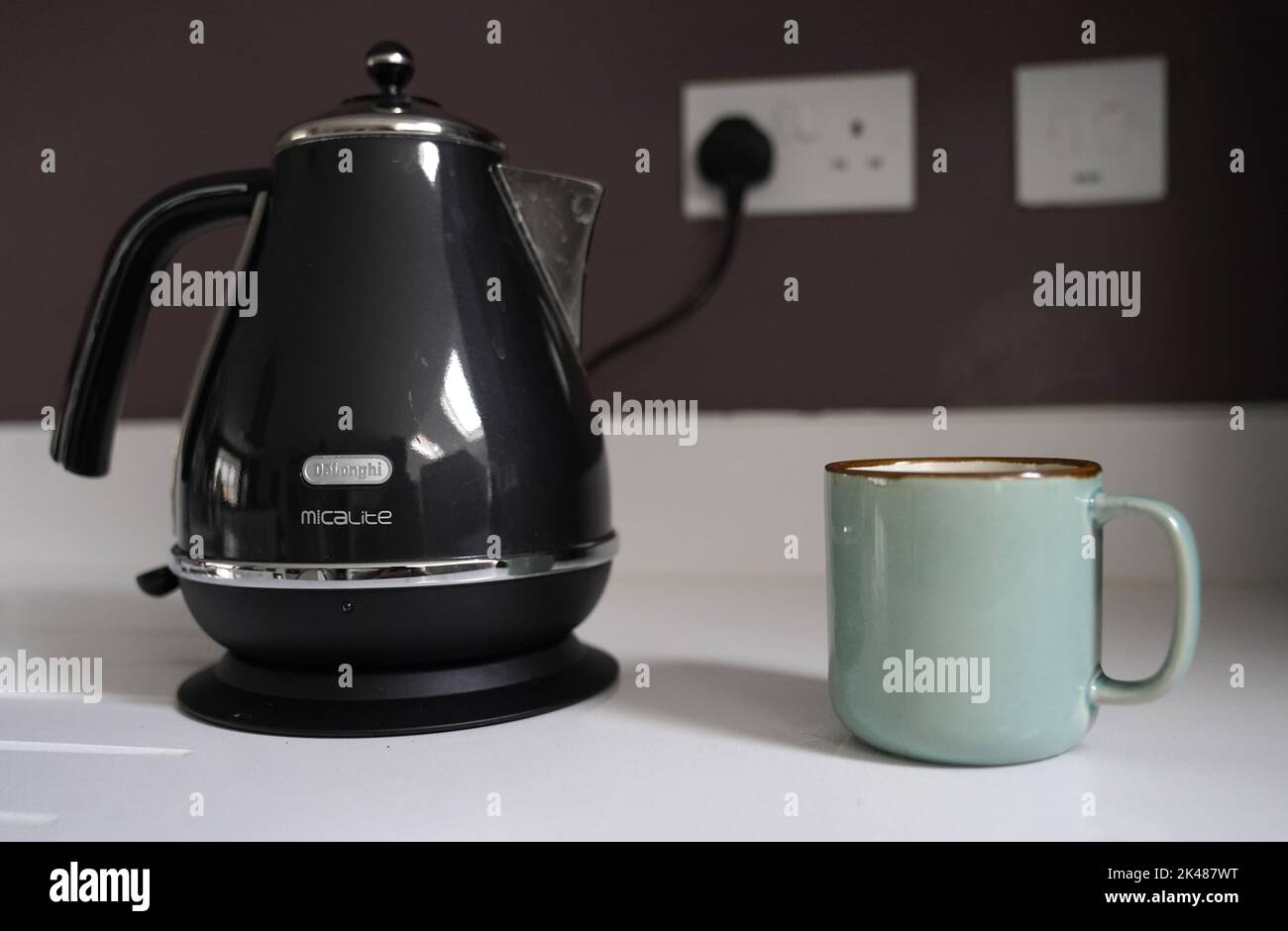File photo dated 03/02/22 of a DeLonghi kettle next to a cup of coffee in a kitchen, as the amount that a household pays for each kilowatt hour of electricity it uses will rise to 34p on Saturday from the already record 28p that families pay today. Stock Photo