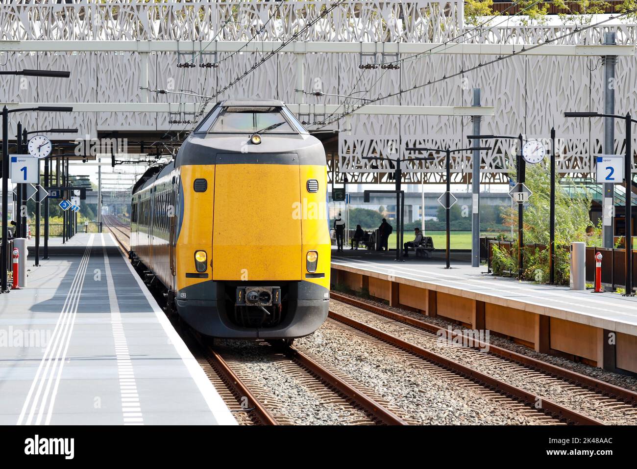 ICM Intercity train called Koploper rushes along platform at station Lansingerland Zoetermeer in the Netherlands Stock Photo