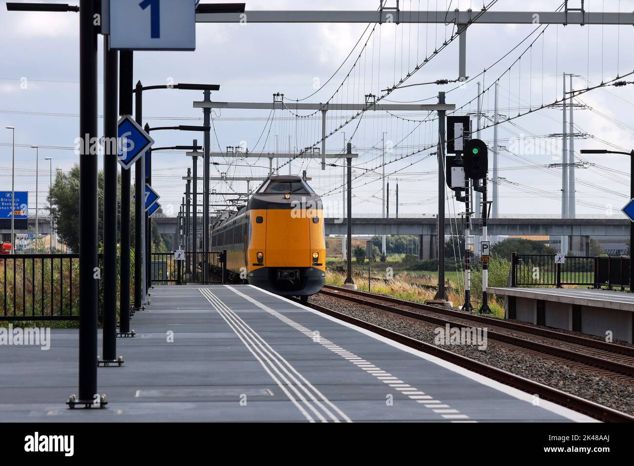 ICM Intercity train called Koploper rushes along platform at station Lansingerland Zoetermeer in the Netherlands Stock Photo