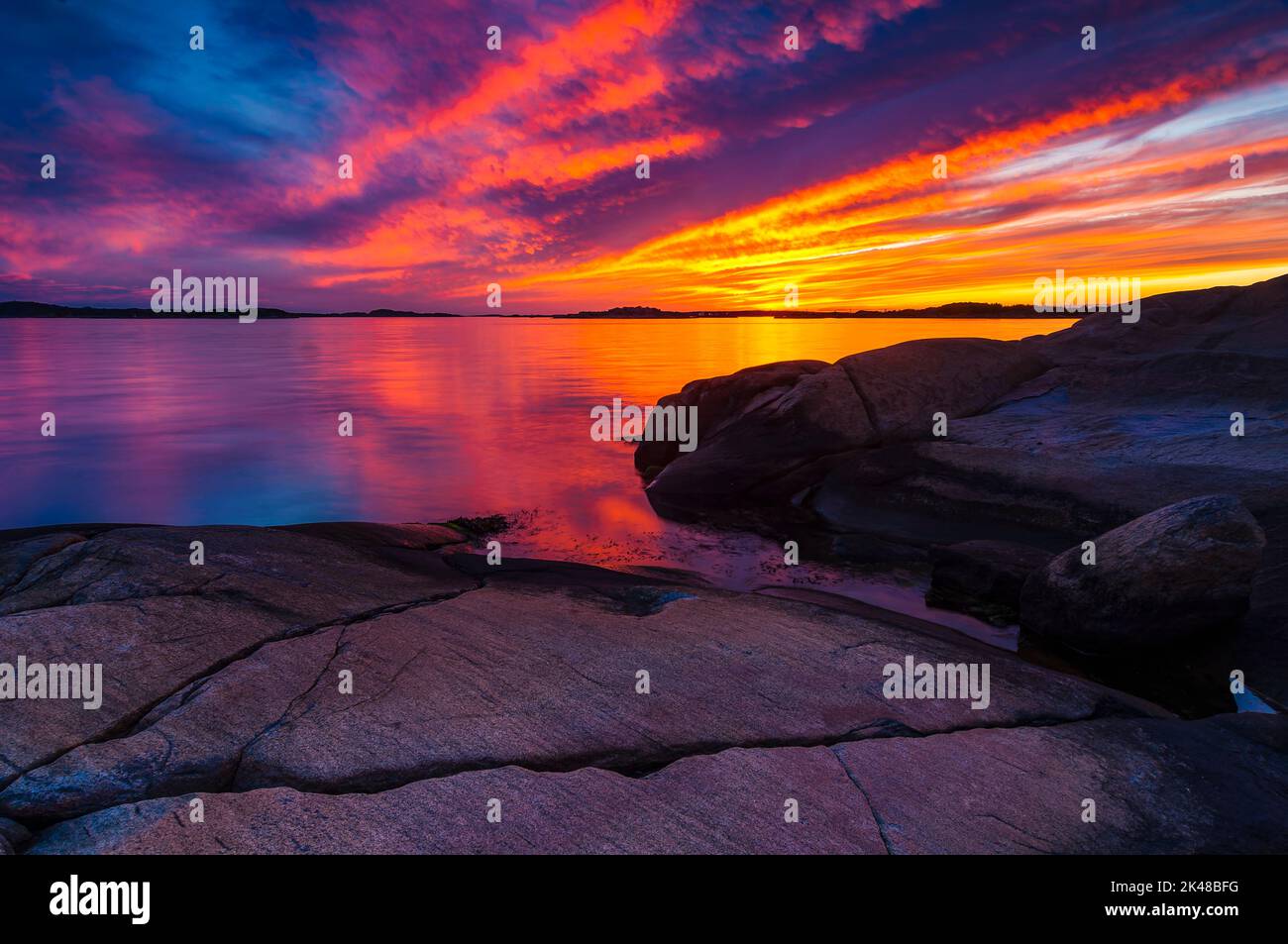 A beautiful view of rocky coastline at sunset with a colorful sky Stock Photo