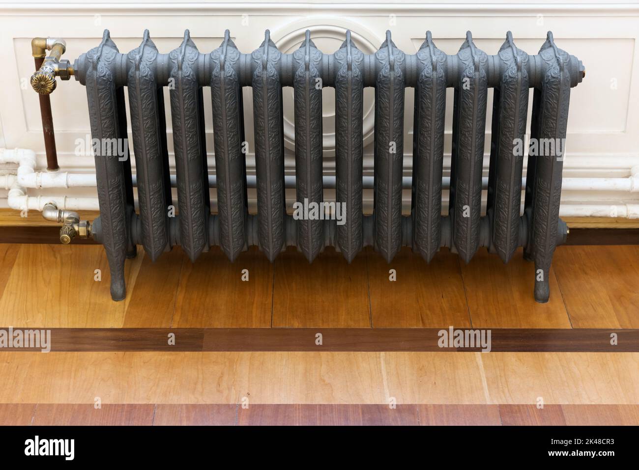 Wintage gray cast iron steam heating radiator, front view, close up photo Stock Photo