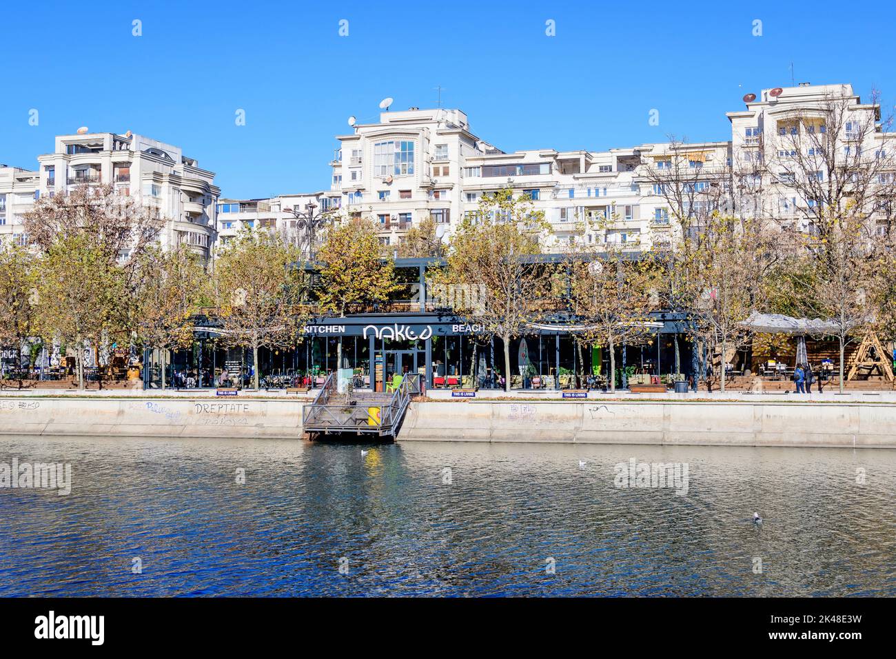 Bucharest, Romania, 20 November 2021: Modern buildings and offices near Dambovita river and cloudy blue sky in the center of the city, in a sunny autu Stock Photo