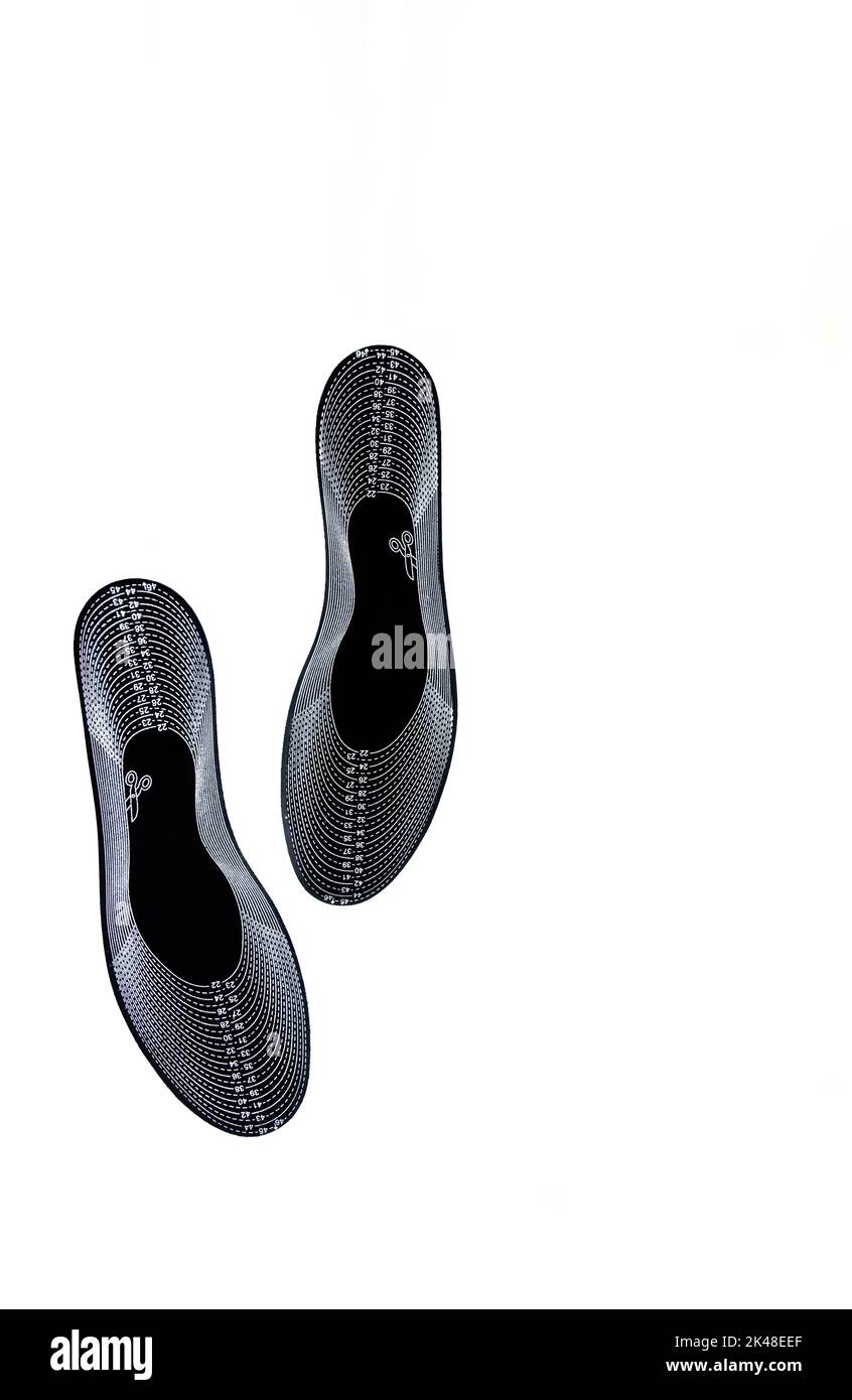 Generic black shoe insoles with different shoe sizes isolated on white background Stock Photo
