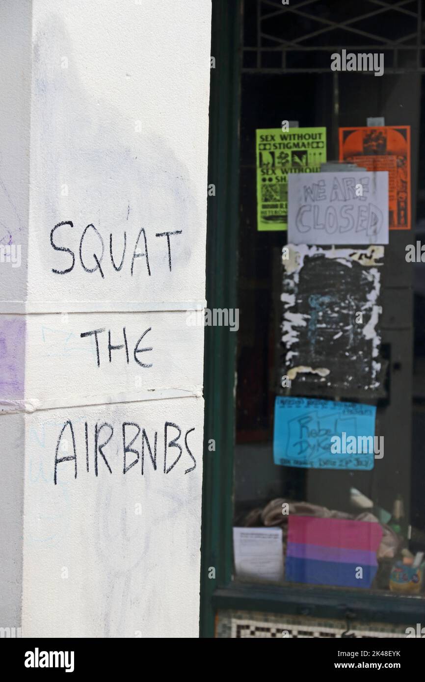 'Squat the airbnbs' graffiti on entrance to shop taken over by squatters, Hebden Bridge Stock Photo
