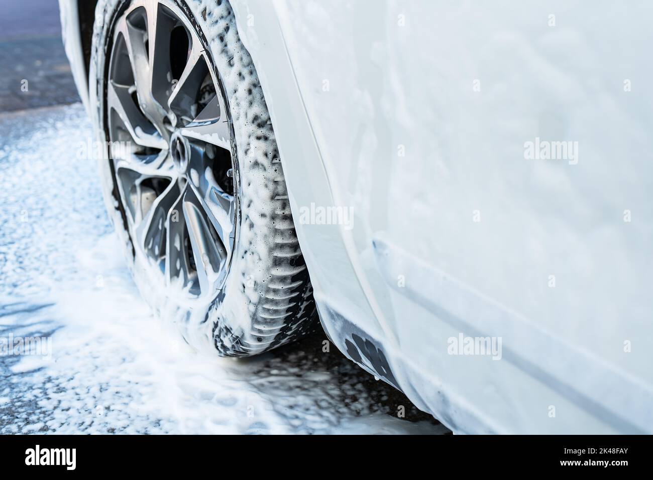 Car wash, white car, wash the car with foam. Selfservice sink Stock
