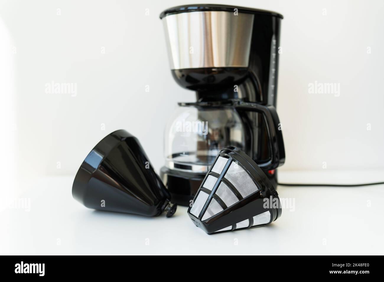 Automatic drip coffee maker isolated on white table. Black modern drip