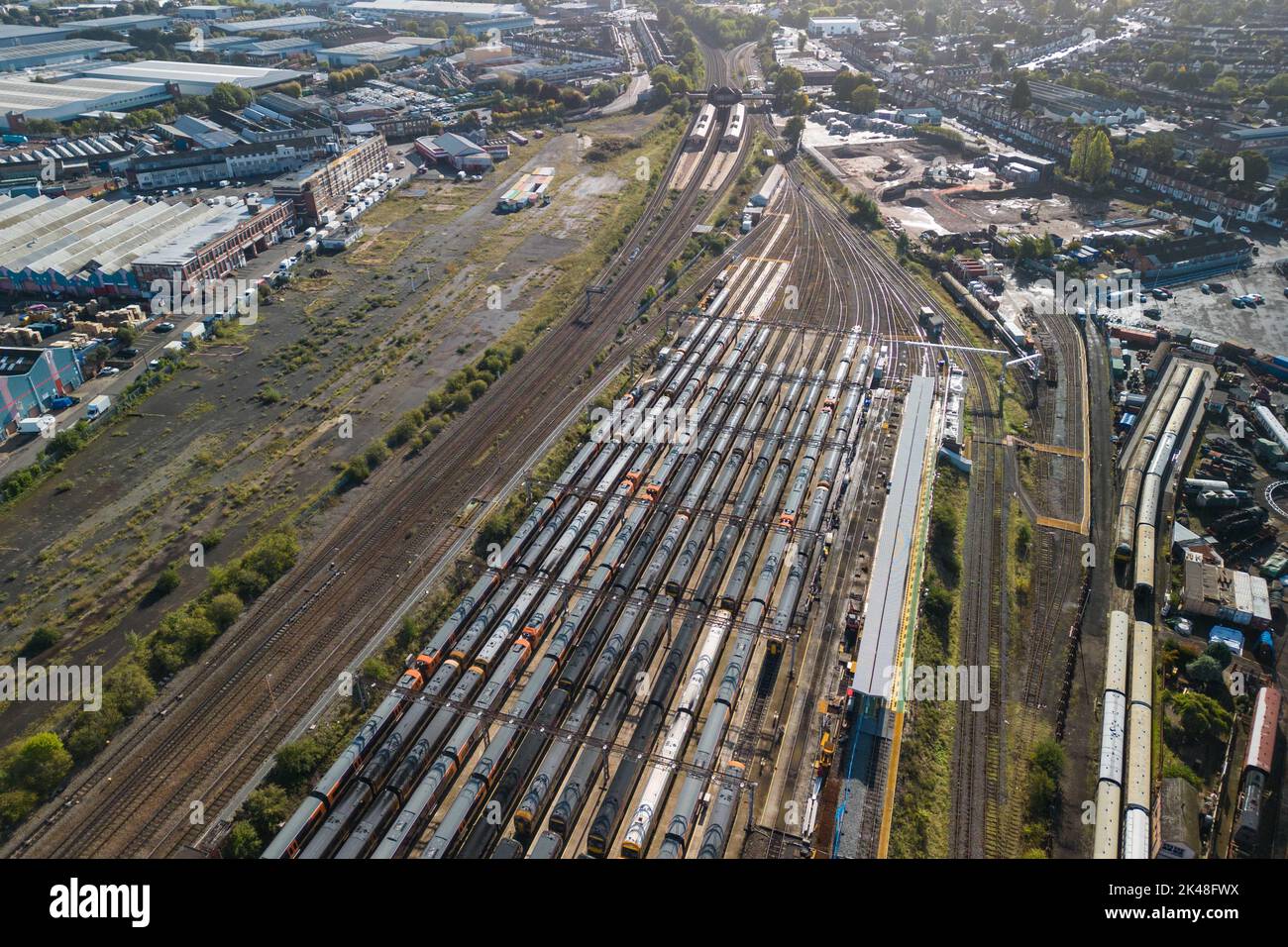 Tyseley, Birmingham, UK. October 1st 2022 - Unused and parked West Midlands Railway trains at the Tyseley train maintenance depot in Birmingham with Tyseley Railway Station in the background as rail workers take part in continued strike action. Pic by Credit: Scott CM/Alamy Live News Stock Photo