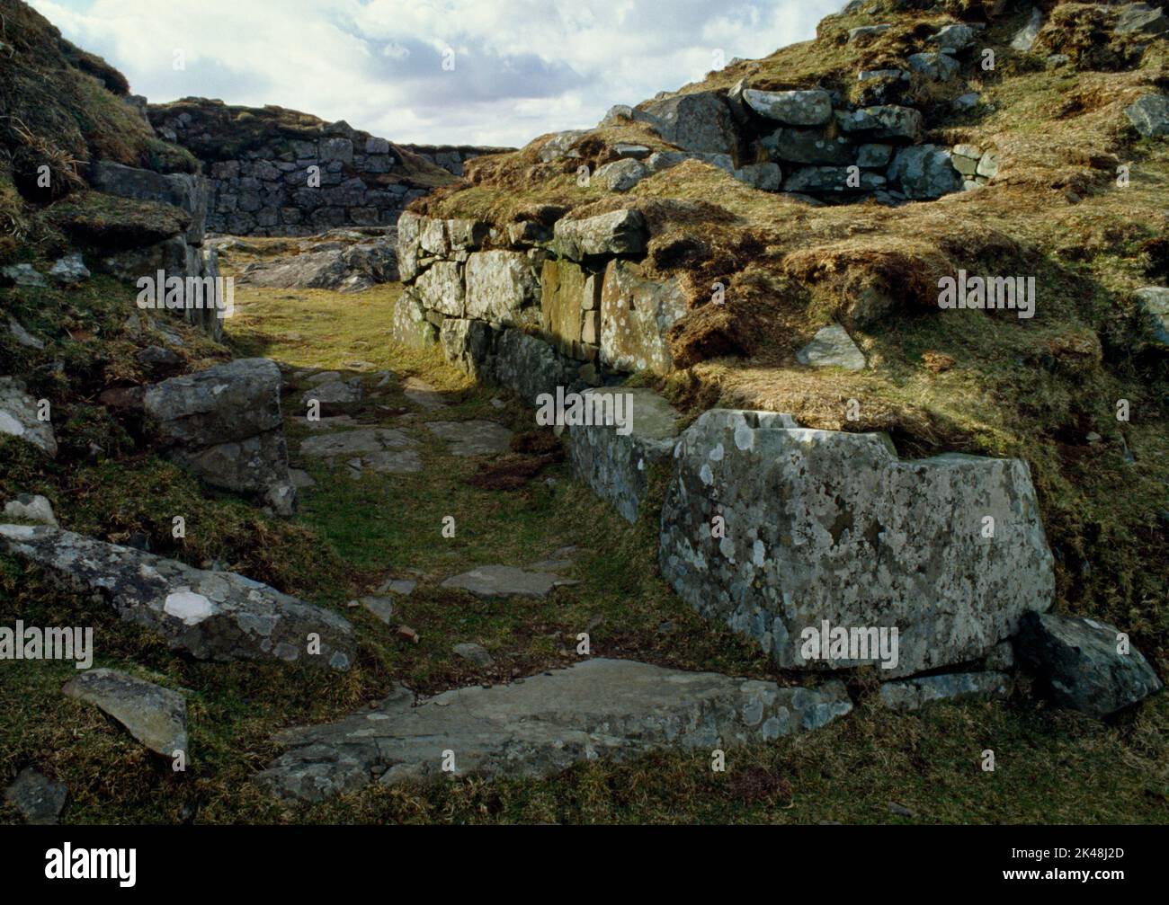 The paved entrance passage of Dun Beag Iron Age broch, Struanmore, Isle of Skye, Scotland, UK, looking NW to the inner court with a corbelled cell (R) Stock Photo