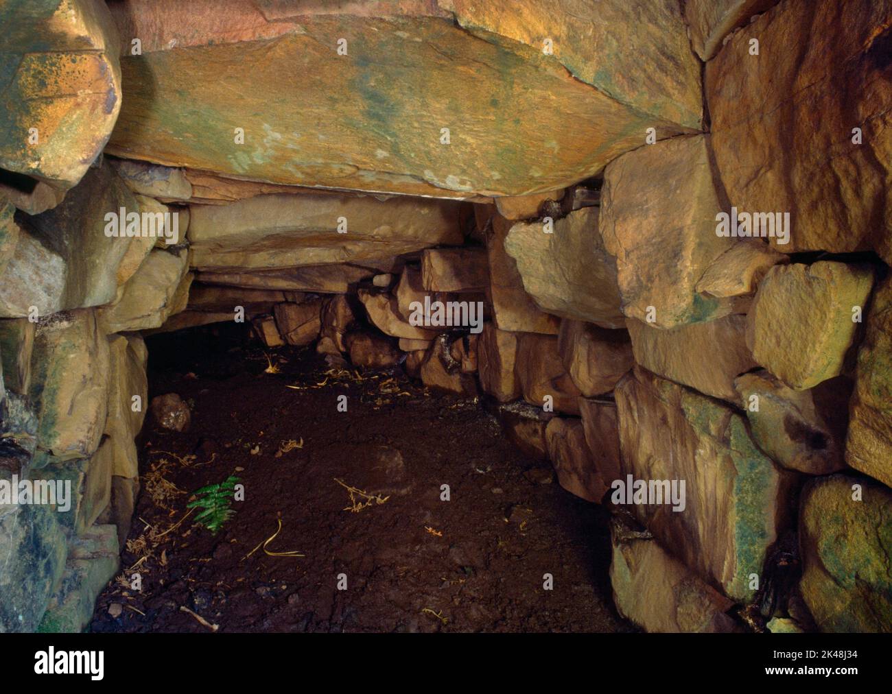 Knock Ullinish Iron Age earth house, Isle of Skye, Scotland, UK, looking NE down the surviving stretch of underground gallery some 4m long. Stock Photo
