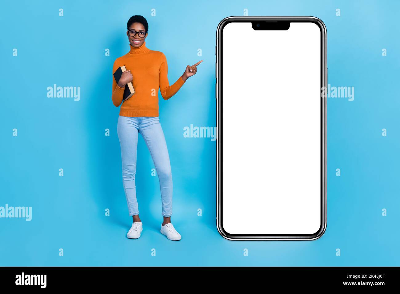 Full body photo of geek nerd trans woman point empty space promote new phone model isolated on blue color background Stock Photo