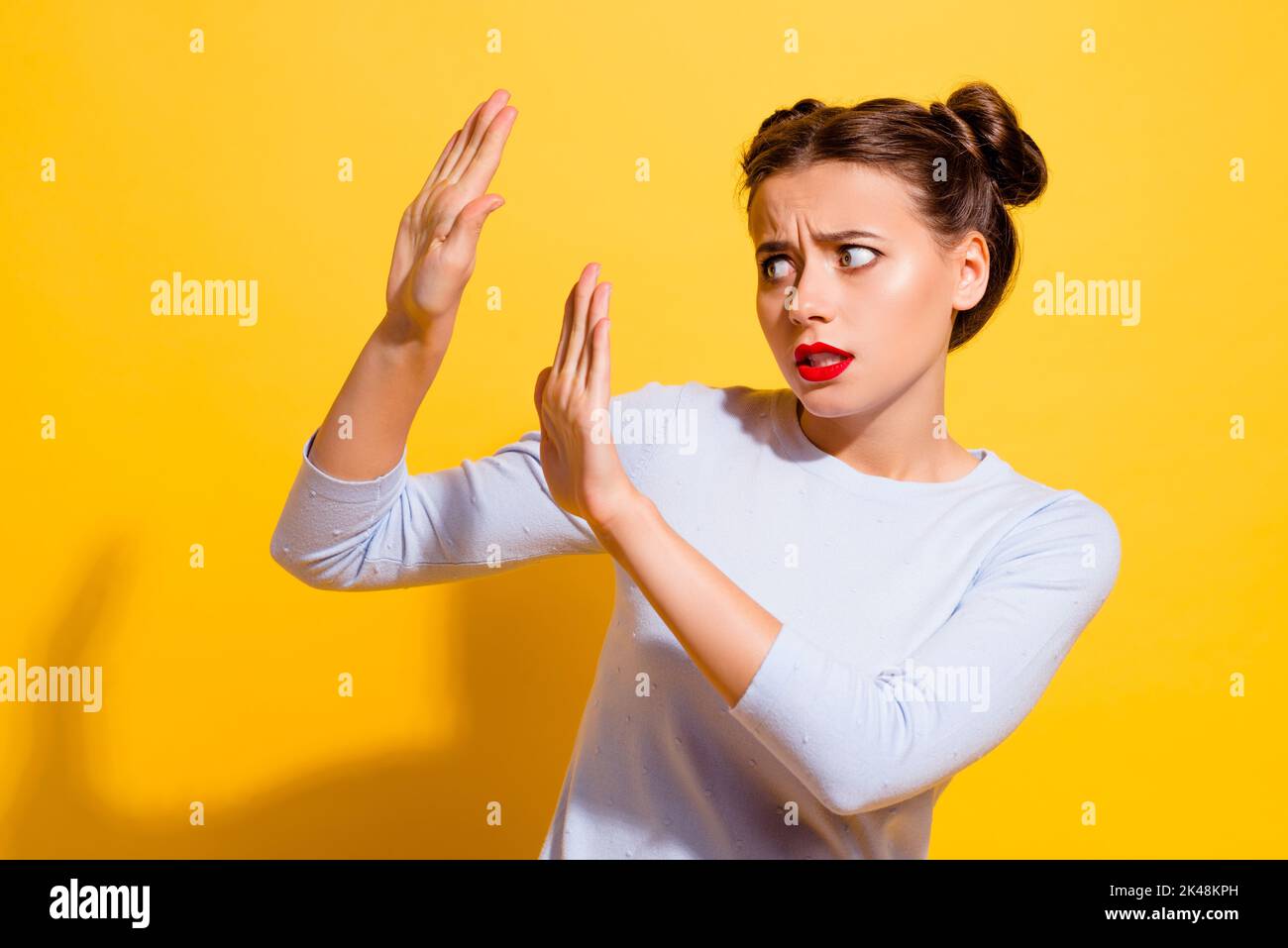 Photo of anxious frustrated lady frightened horror ignore with palms look empty space isolated bright color background Stock Photo