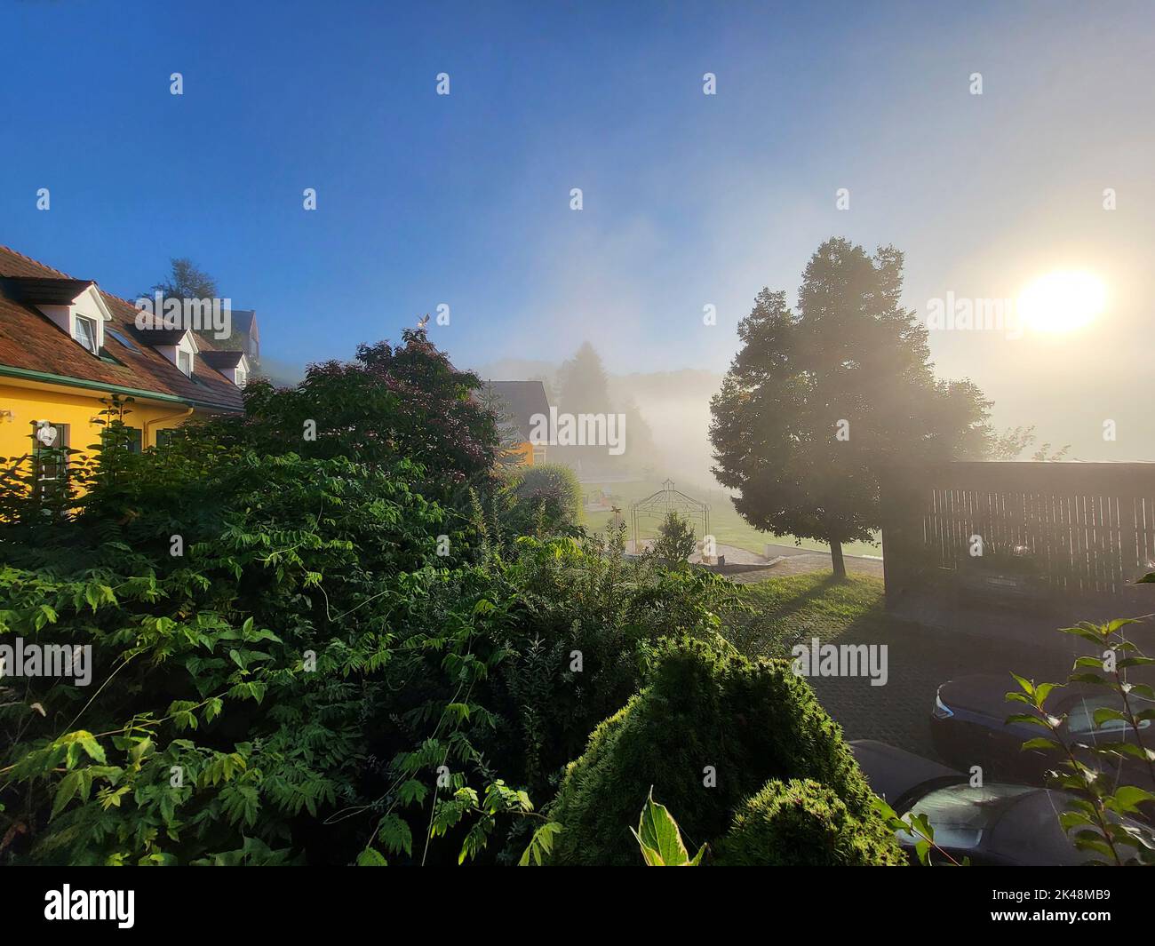 Kitzeck im Sausal, Austria - September 20, 2022: Guesthouse in the mountain village in Southern Styria with morning fog, the area is well known for sp Stock Photo