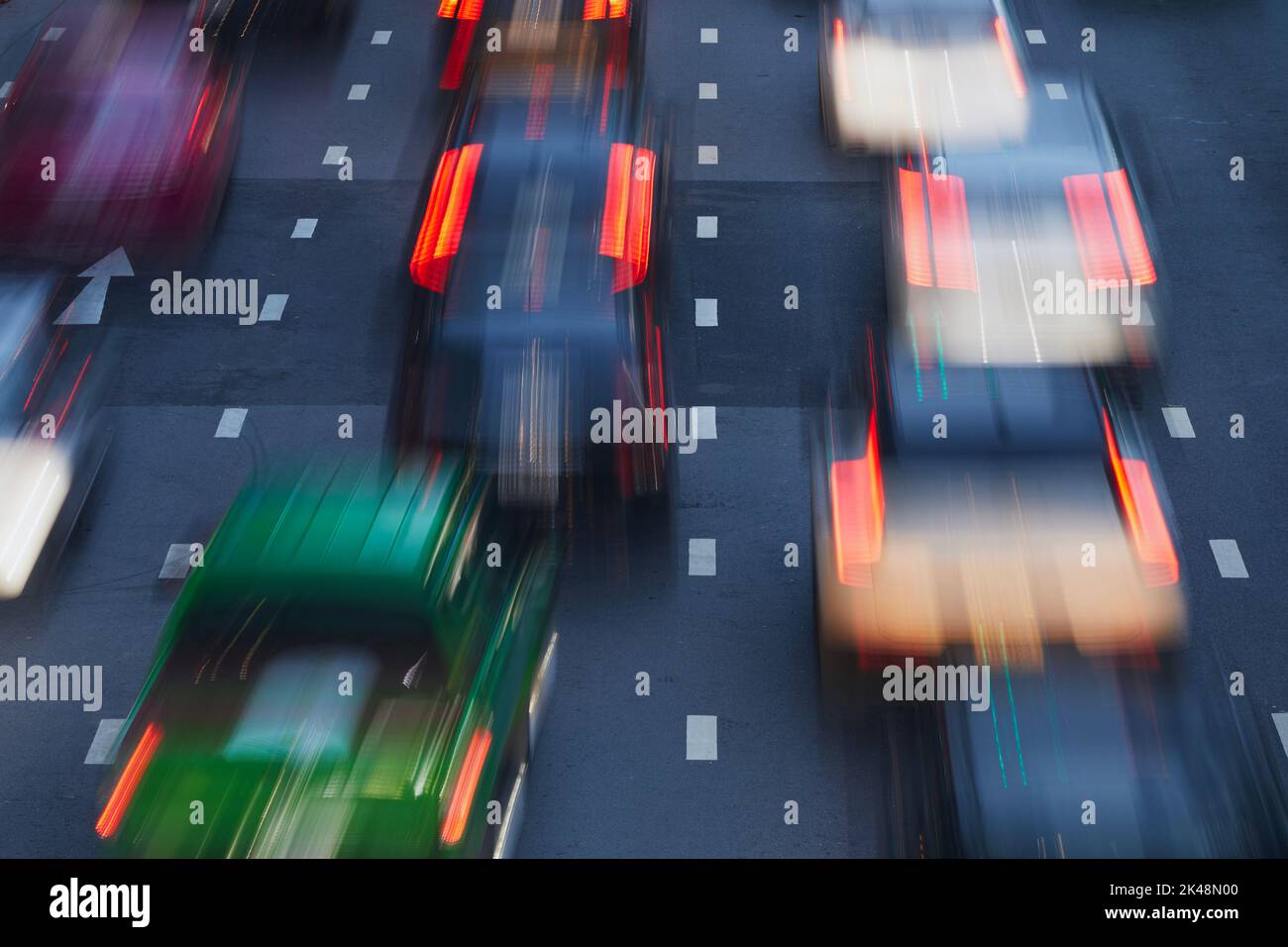 Cars in blurred motion on urban road during evening traffic jam. City street in Bangkok, Thailand. Stock Photo
