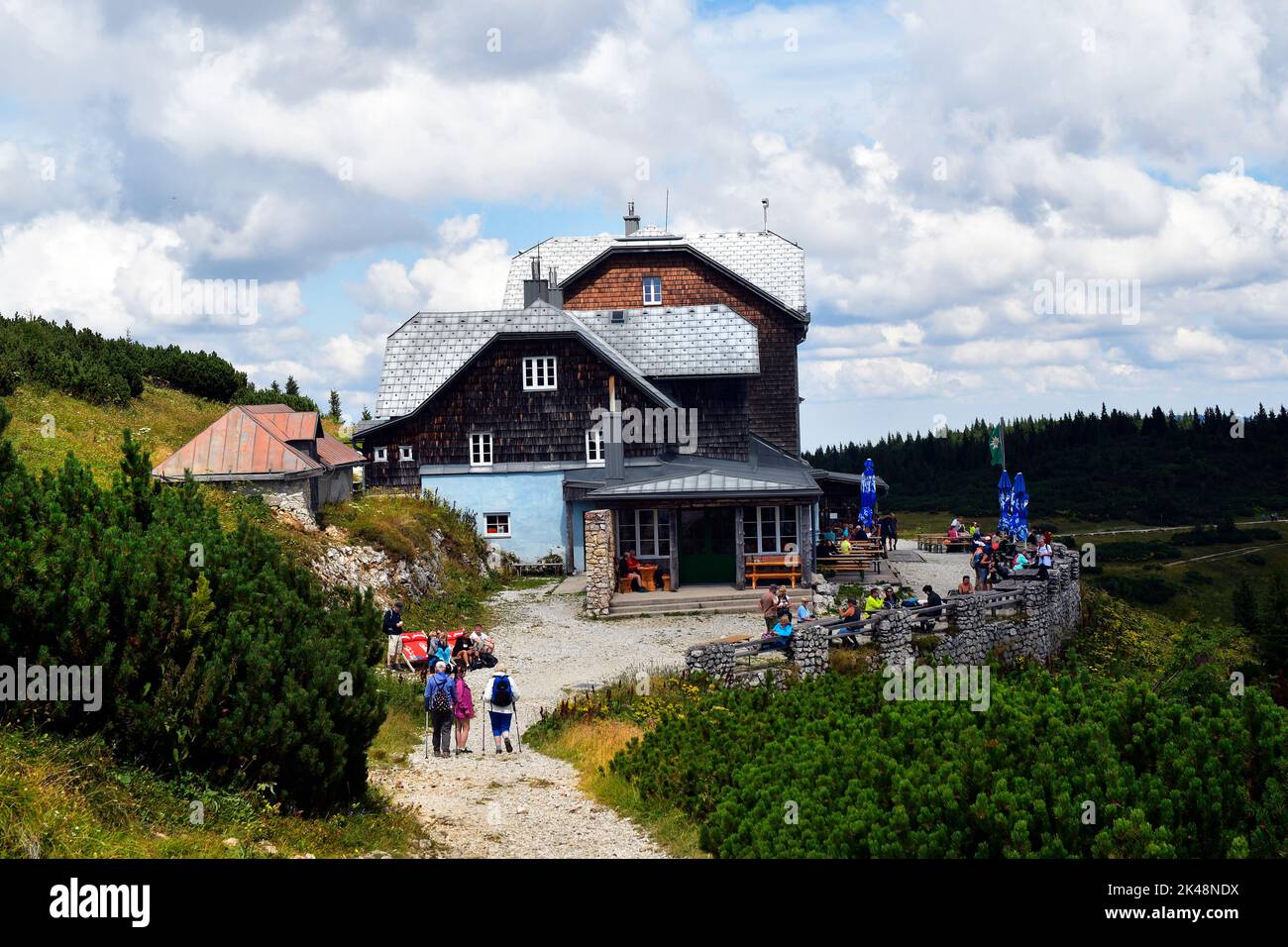 Hirschwang, Austria - August 10, 2022: Unknown hikers take a break at the mountain inn called Ottohaus on Rax mountain in Lower Austria, part of the V Stock Photo
