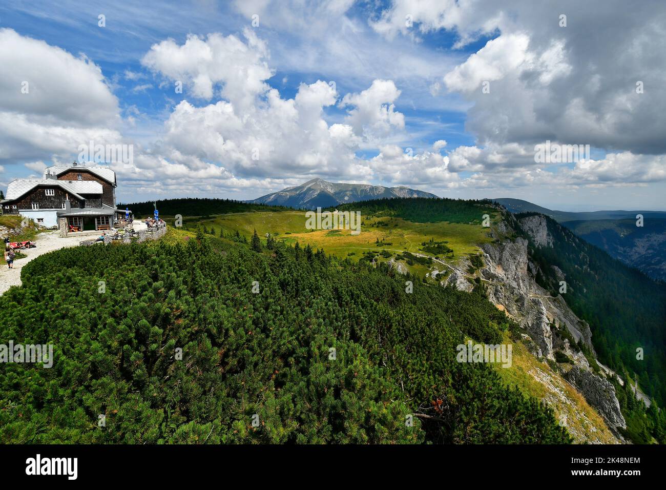 Hirschwang, Austria - August 10, 2022: Unknown hikers take a break at the mountain inn called Ottohaus on Rax mountain in Lower Austria, Schneeberg mo Stock Photo