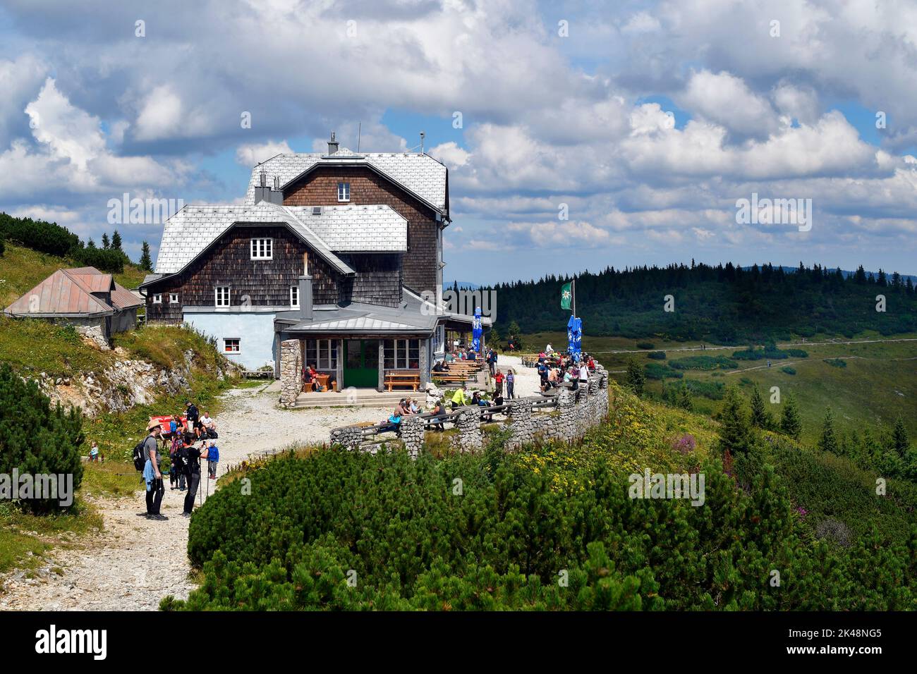 Hirschwang, Austria - August 10, 2022: Unknown hikers take a break at the mountain inn called Ottohaus on Rax mountain in Lower Austria, part of the V Stock Photo