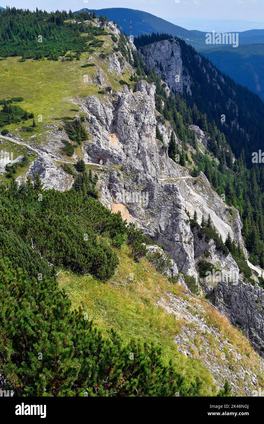Austria, Rax mountain in Lower Austria, footpath along rocks and through rock window named Devils Hole aka Teufelslucken in german Stock Photo